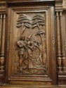 Carved cabinet door showing an assassin